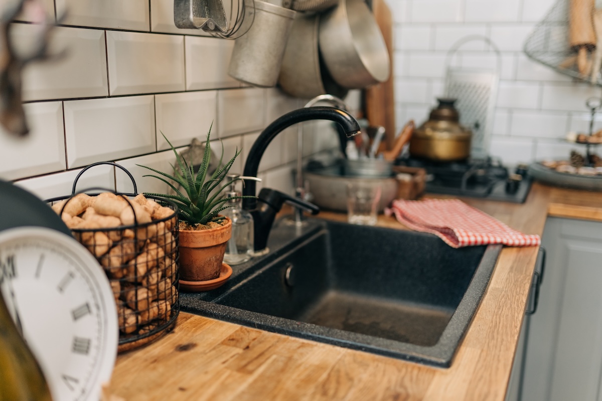 A modern dark slate-colored kitchen sink.