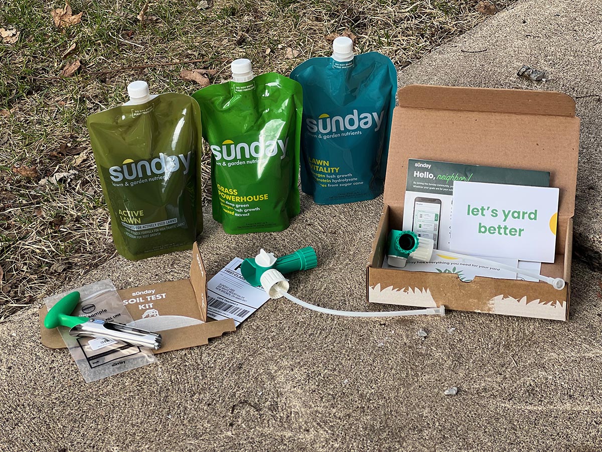 A Sunday lawn care kit is shown arranged on concrete.
