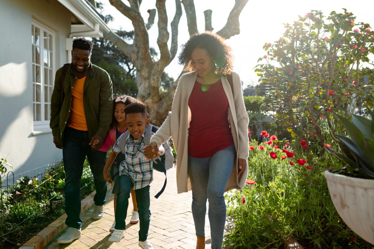 A family gets ready to leave their home for vacation.