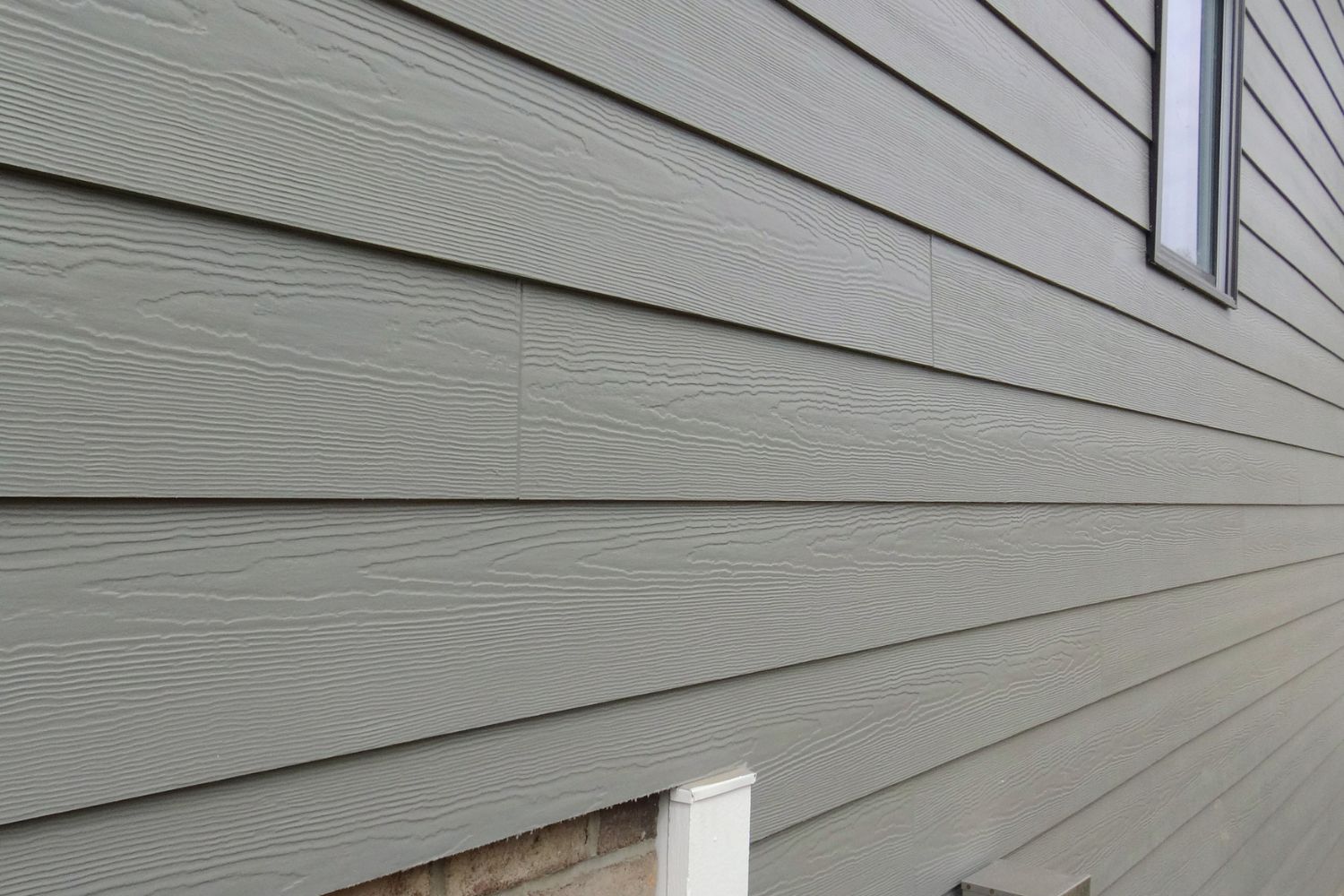 A close up of brand new siding on a house.