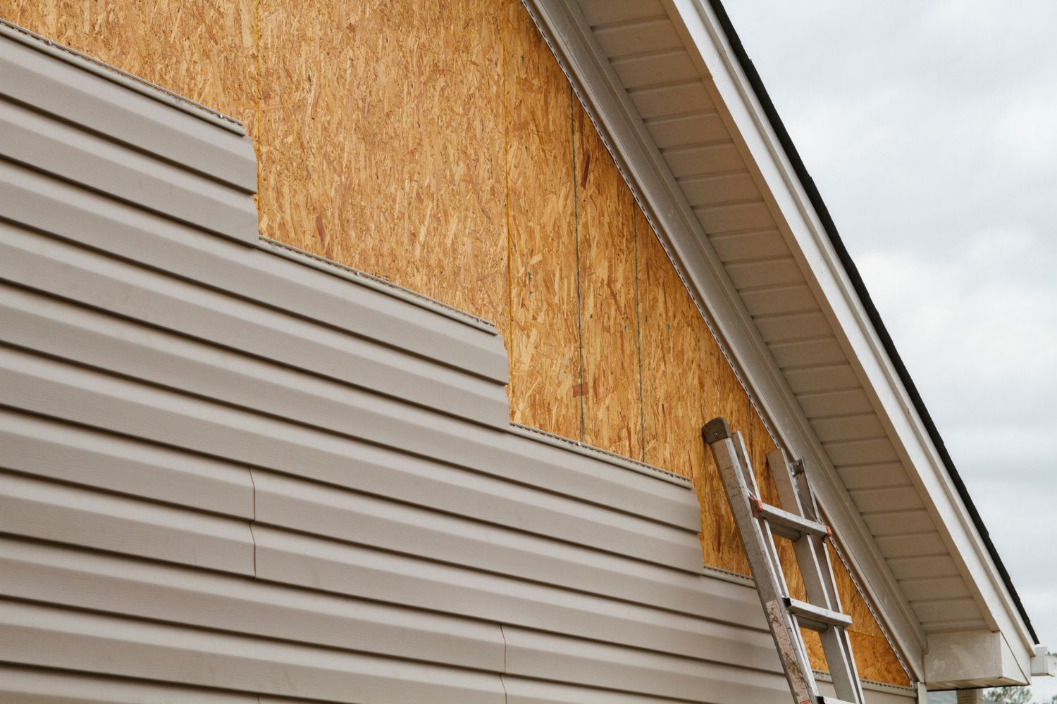 A close up of new siding being installed on a house. 