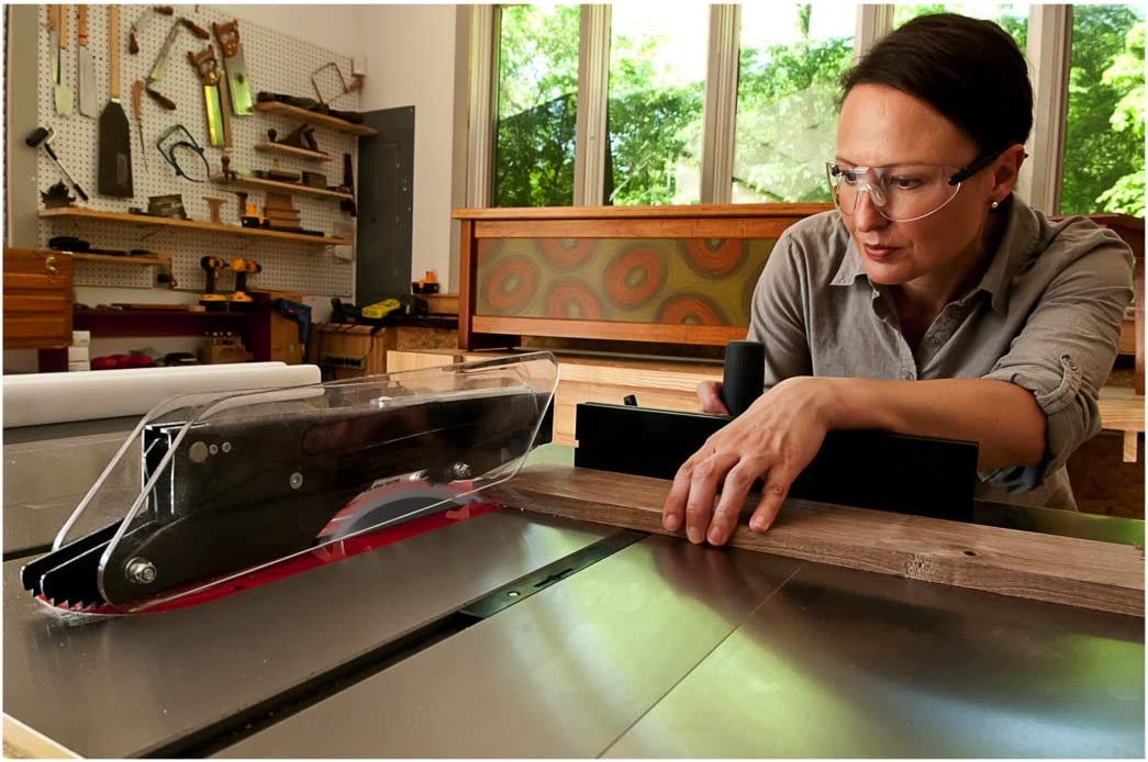 A close-up of a person concentrating while making a cut using the best cabinet table saw option