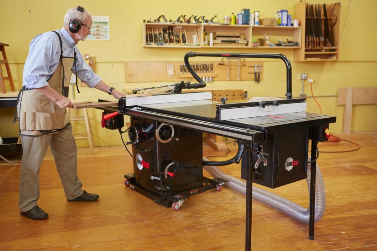 A person using the best cabinet table saw option in a workshop
