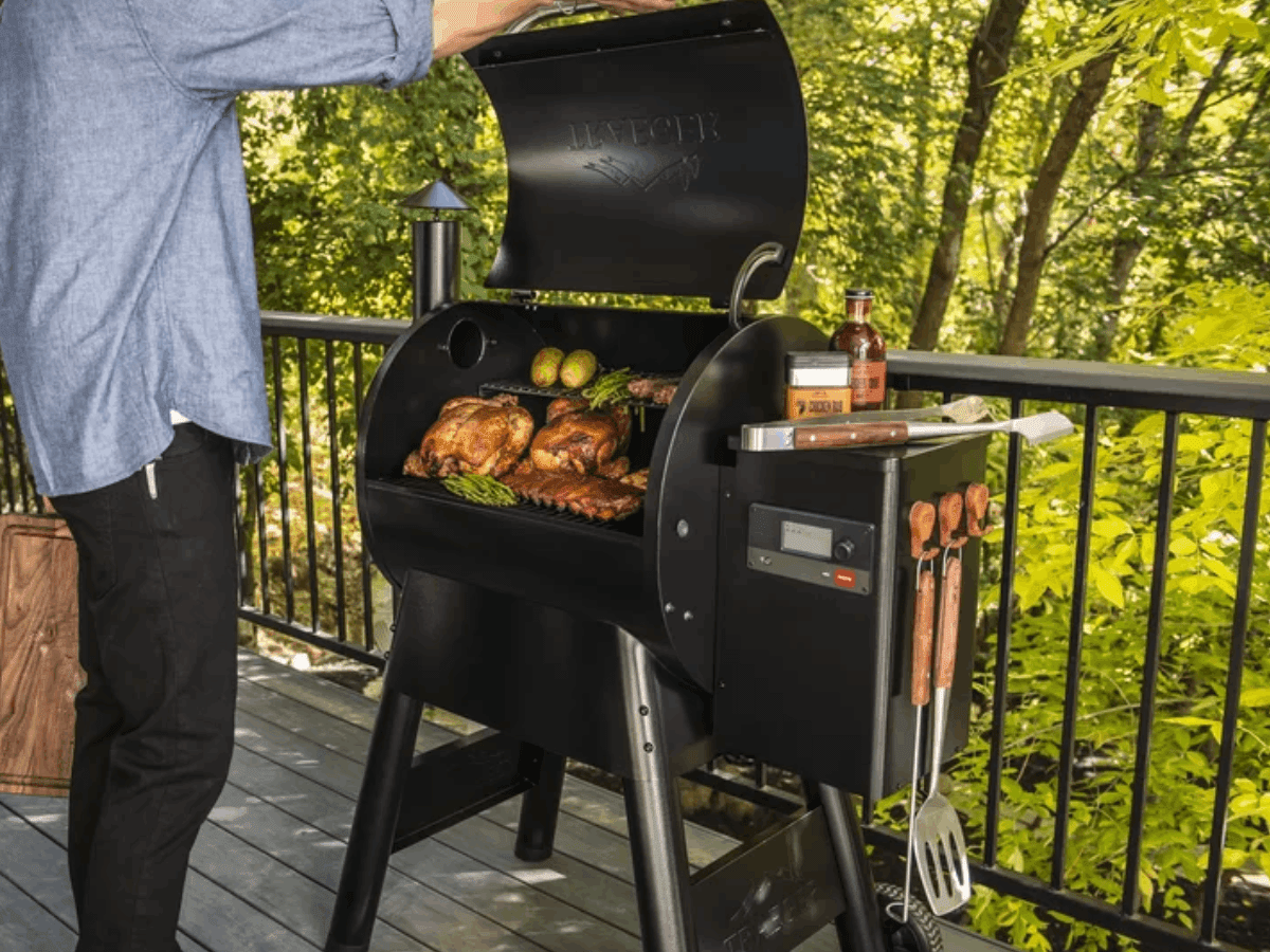 A person using a Traeger smoker