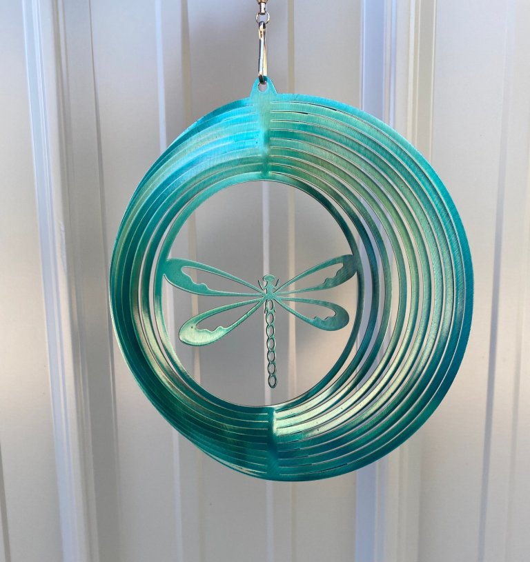 The R Mountain Metal Decor Dragonfly Wind Spinner hanging in front of a white background