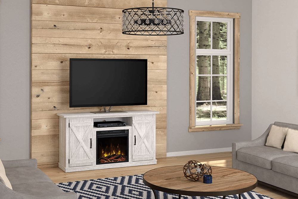 The best electric fireplace TV stand set up in a rustic living room to hold a TV while displaying a glowing fire.