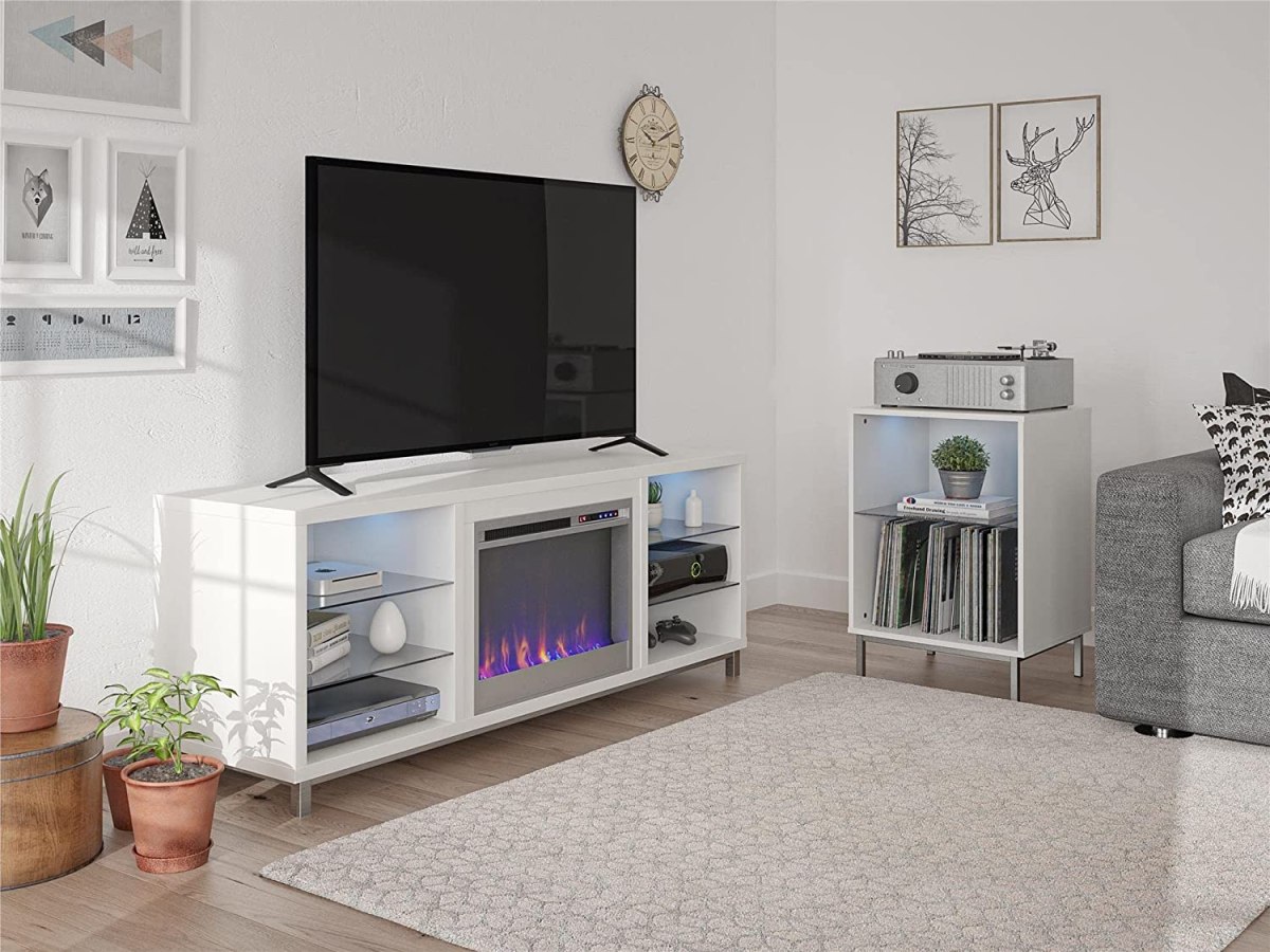 The best electric fireplace TV stand set up in a bright living room and displaying a fire while holding a TV and other decor items.