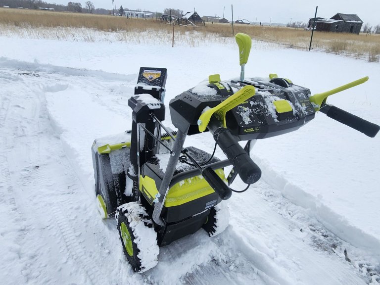 cleaning the snow with Ryobi Two-Stage Cordless Snow Blower