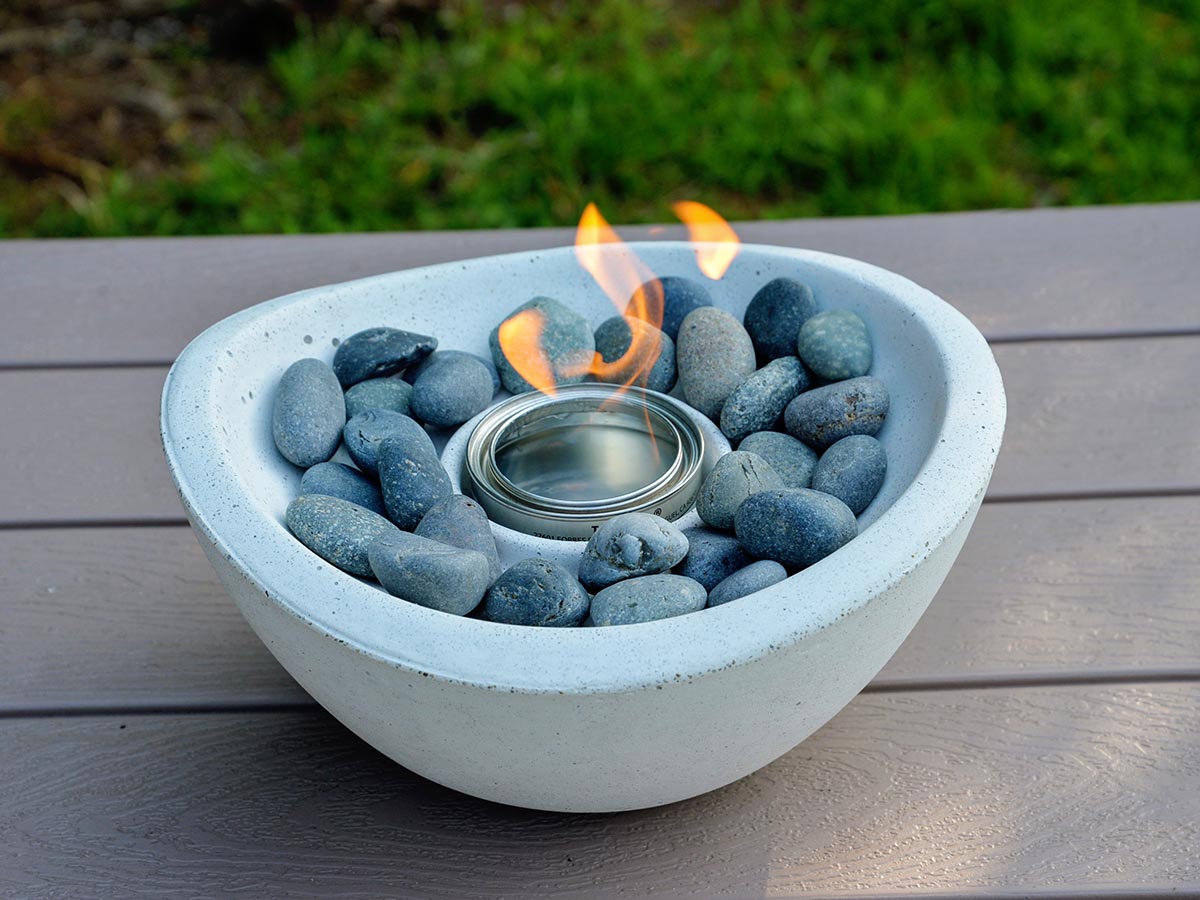 The TerraFlame Wave Tabletop Fire Bowl on an outdoor picnic table during testing.