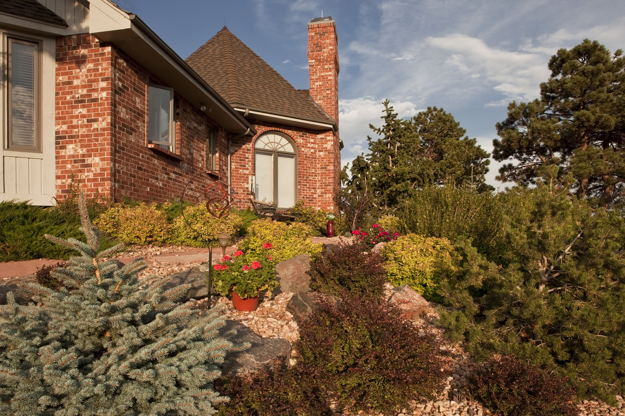 A home with detailed front yard landscaping. 