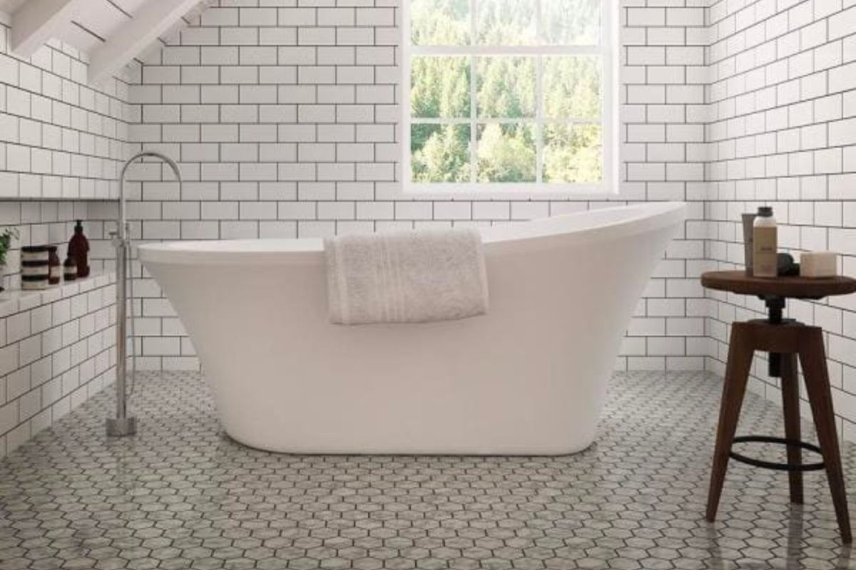 The best freestanding tub option installed in a beautiful white-tiled bathroom