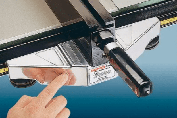 A close-up of a person making an adjustment to the best table saw fence option