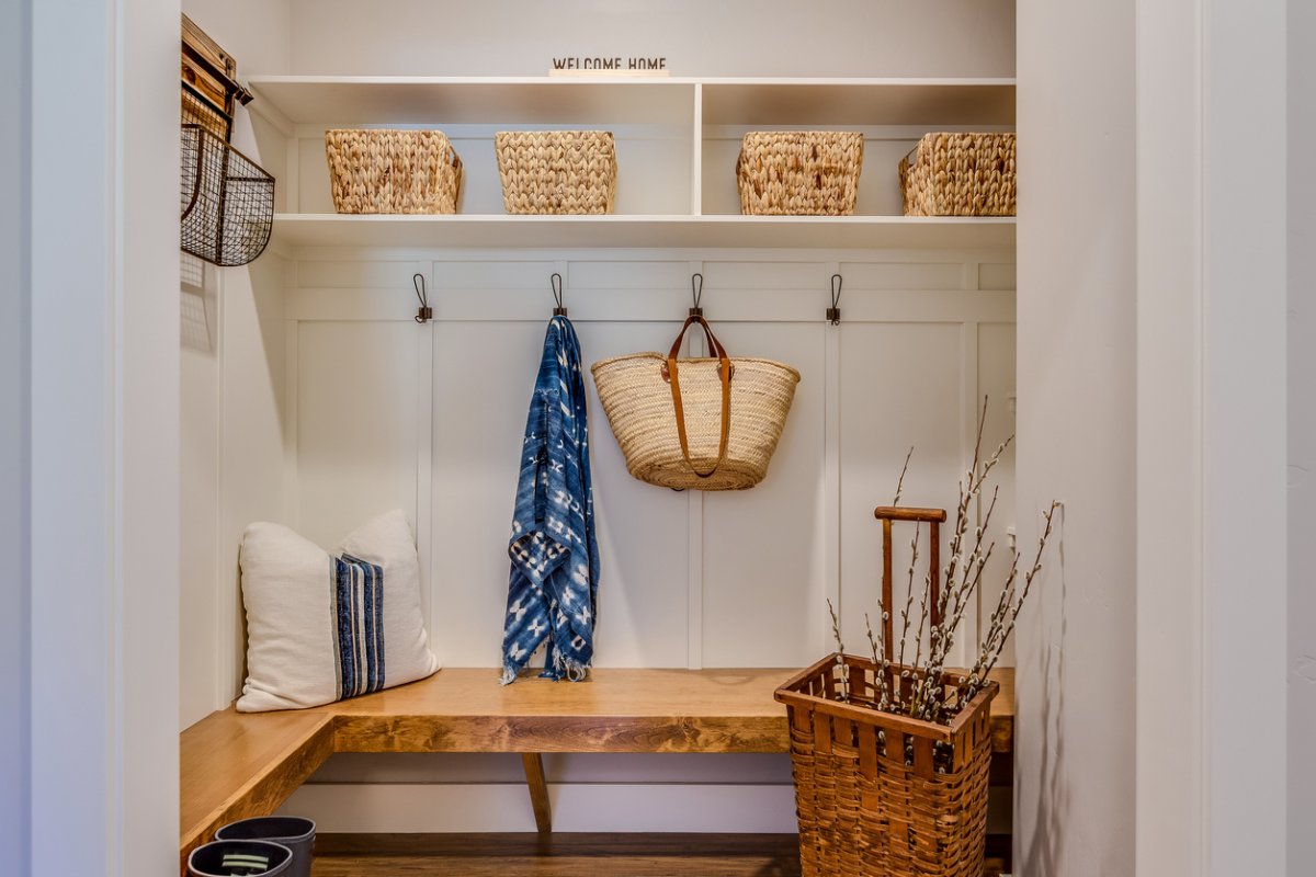 Natural wood bench and cubbies with baskets is a designer's dream