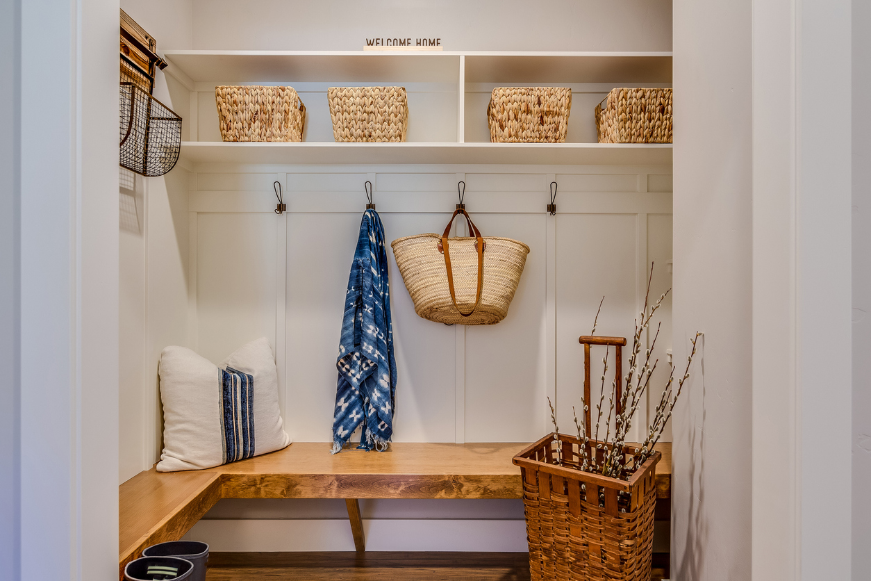 Natural wood bench and cubbies with baskets is a designer's dream