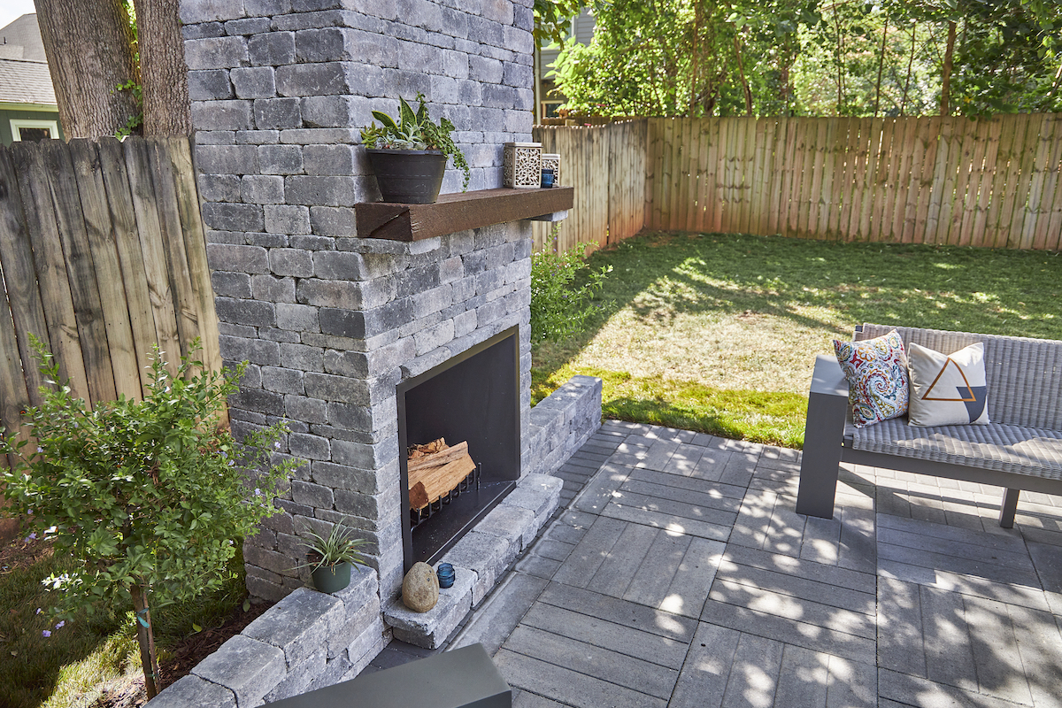 Pavestone outdoor fireplace fall patio season trends 2022