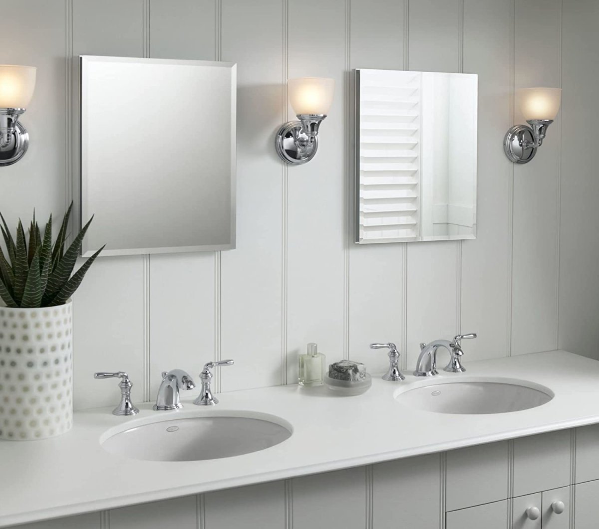 Kohler frameless mirrored medicine cabinets over a double vanity.