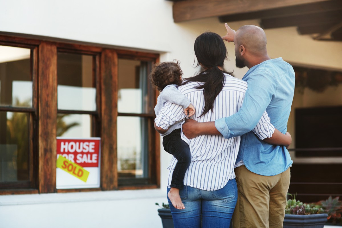 house buying has changed family in front of new house
