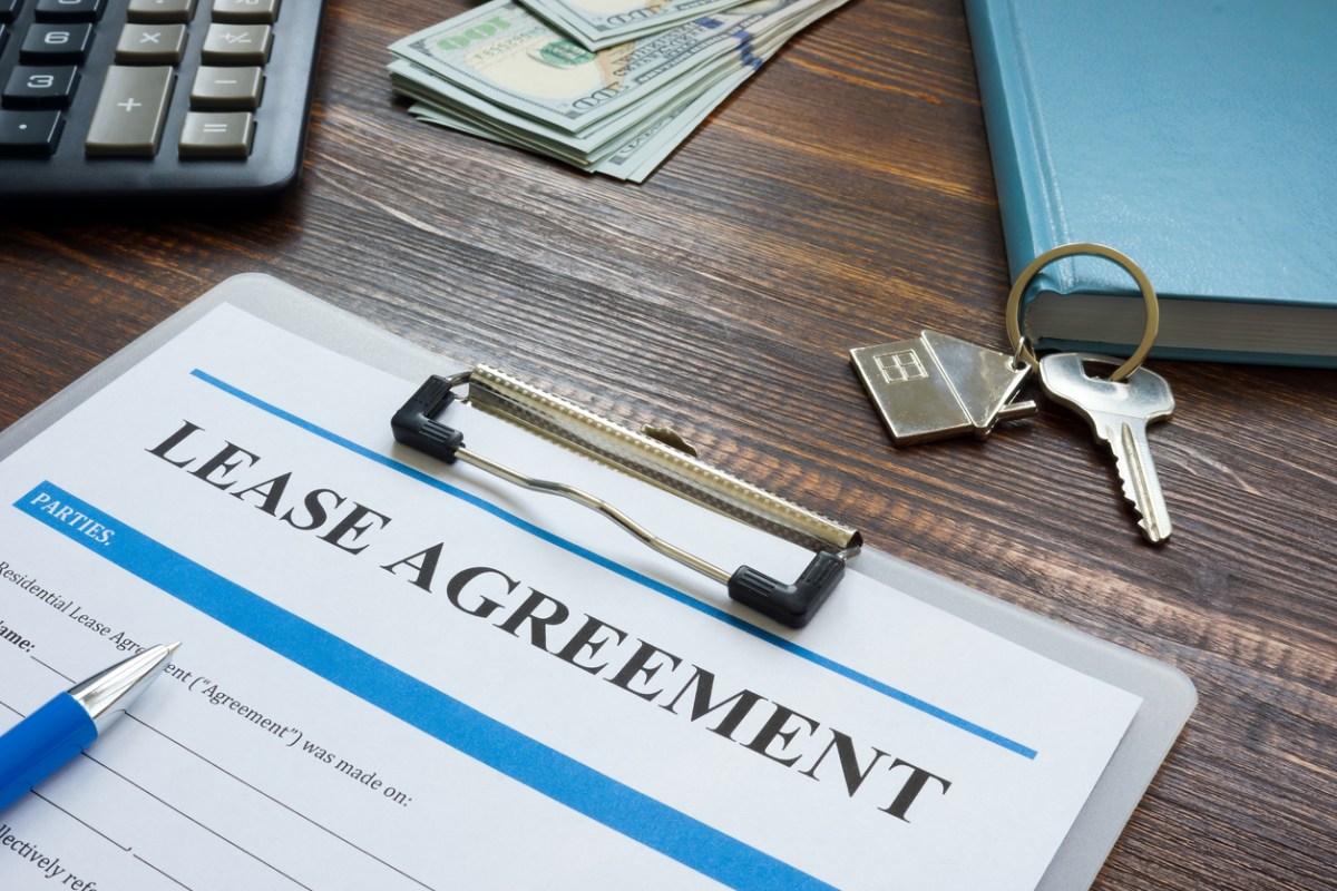 rental inspection checklist lease agreement on desk with keys