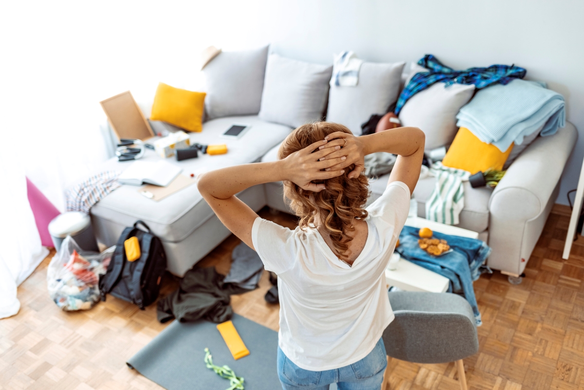 how to declutter your home - woman looking at clutter