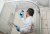 An inspector uses a phone to photograph mold in a shower.