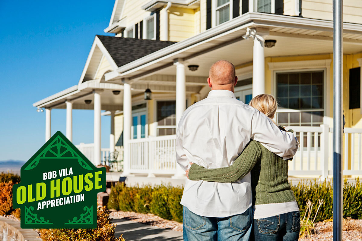 guide to buying old homes by decade couple admiring old yellow house