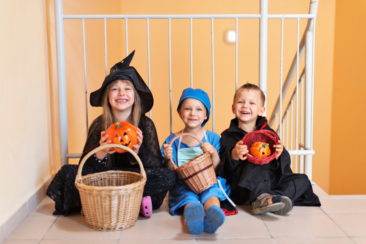 trick or treating kids in costumes in the hall