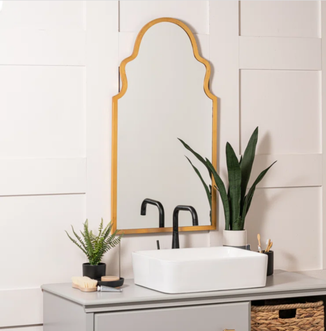 Art deco-style mirror with curved arch shapes on the top corners