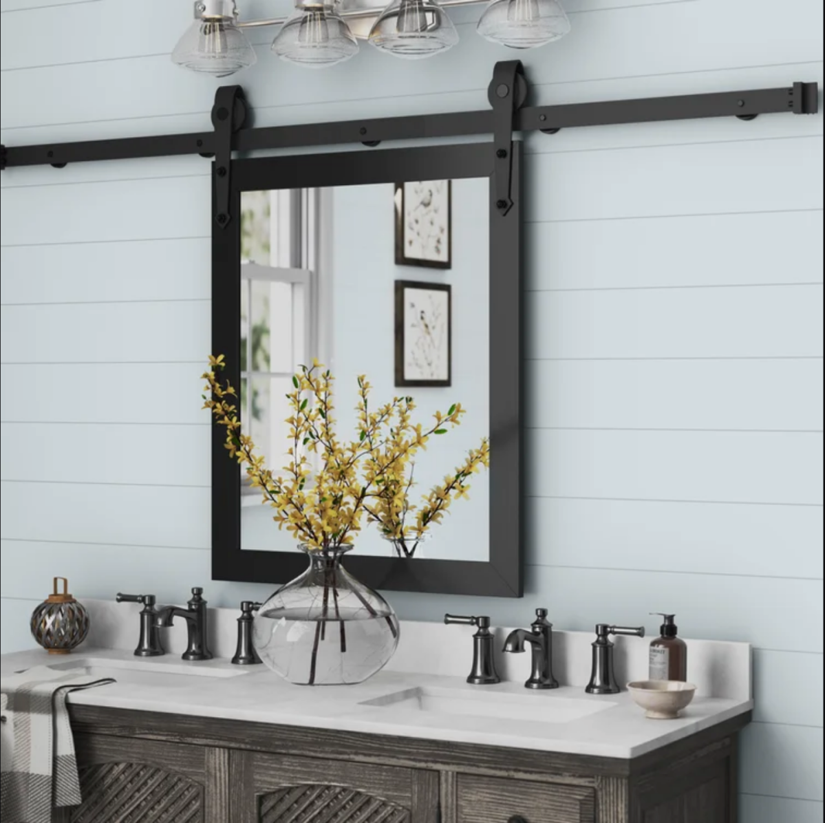Mirror hanging on a black barn door track.