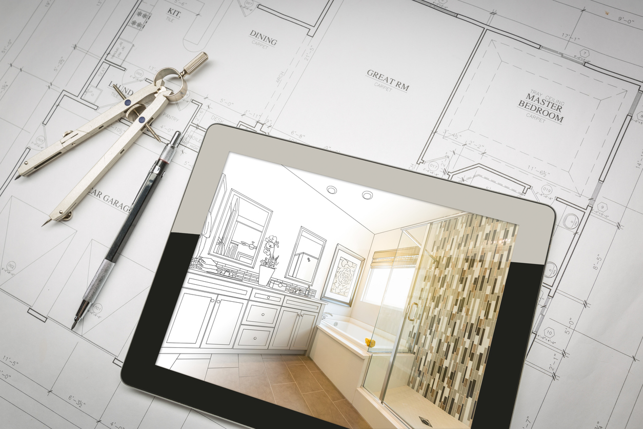 A tablet with a bathroom remodel design displayed on the screen sits on top of a home blueprint with a pen and protractor alongside it.