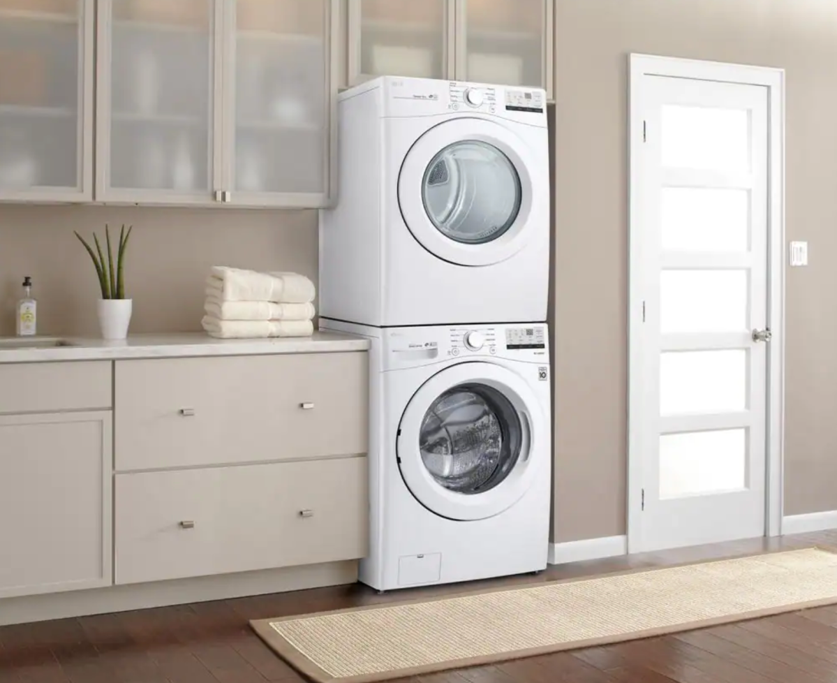 A stacked washer/dryer combo in a house.