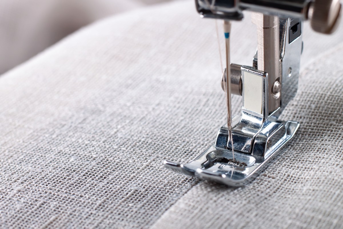 Sewing machine presser foot on gray fabric