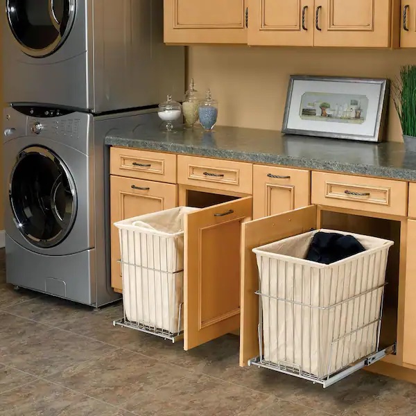 hidden laundry baskets inside light brown cabinets