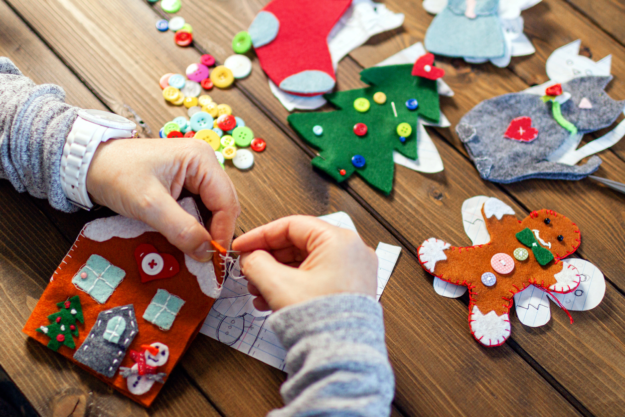 Person making felt Christmas ornaments.