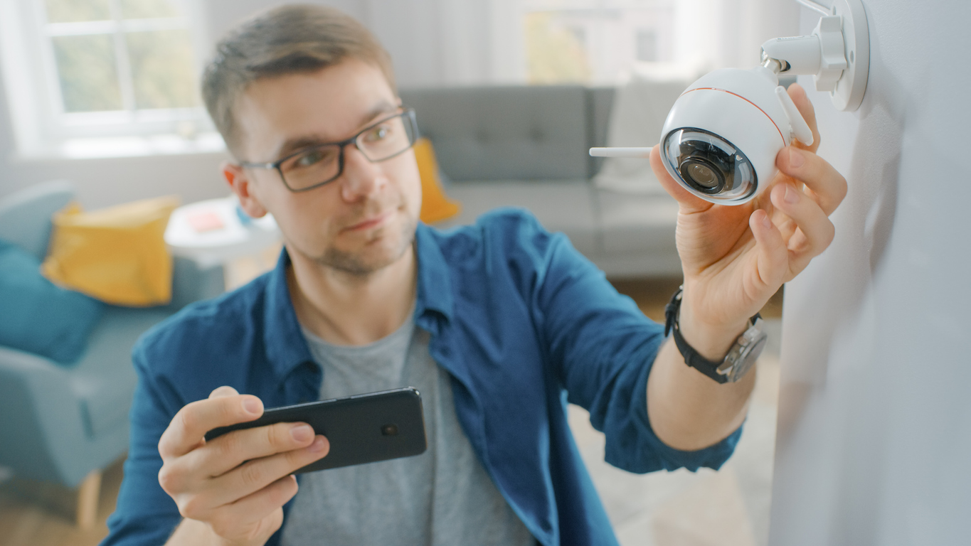 Man checking smart security camera.