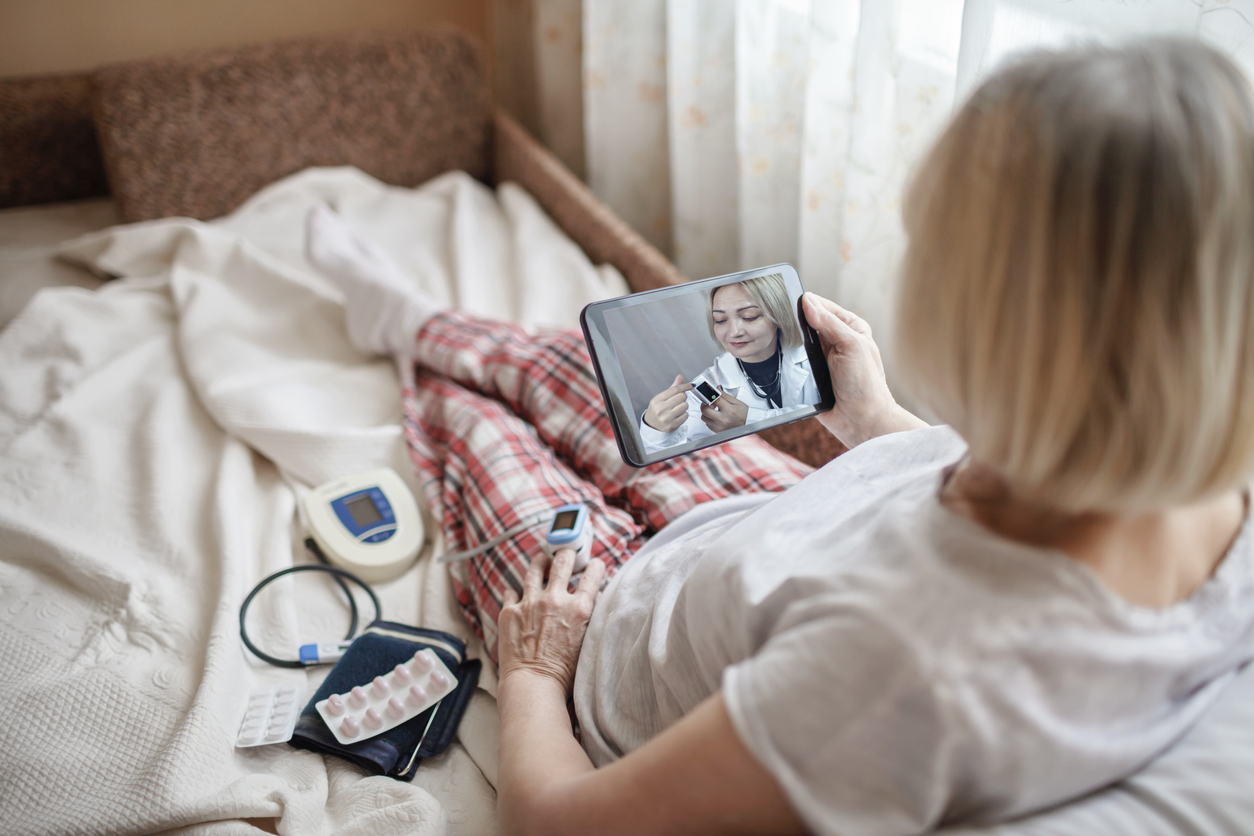 iStock-1295613094 home health care woman monitoring vital signs with tablet