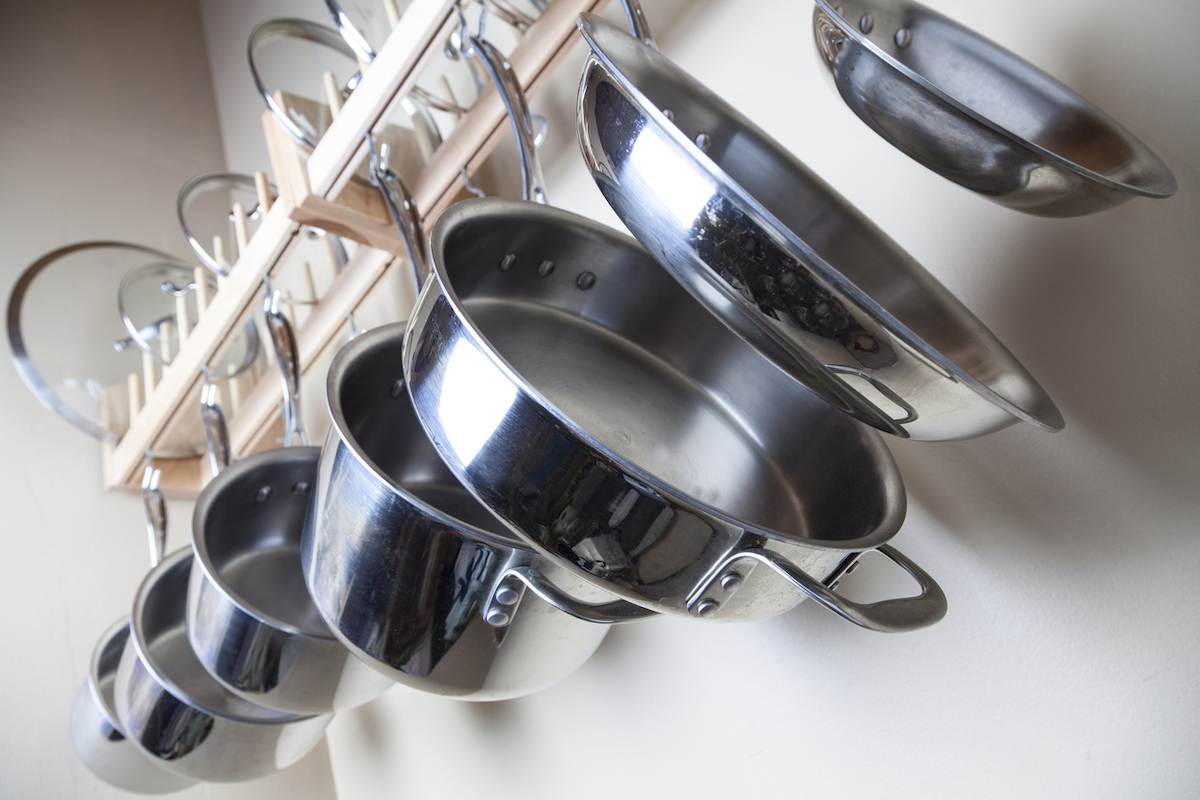 stainless steel cookware on pot rack