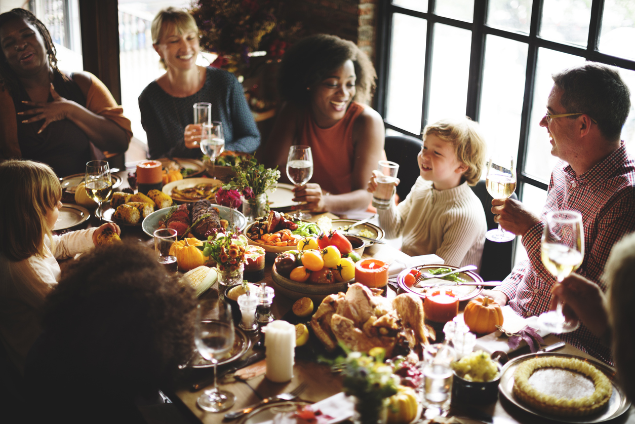 iStock-614333576 turkey shortage family and friends around the thanksgiving table.