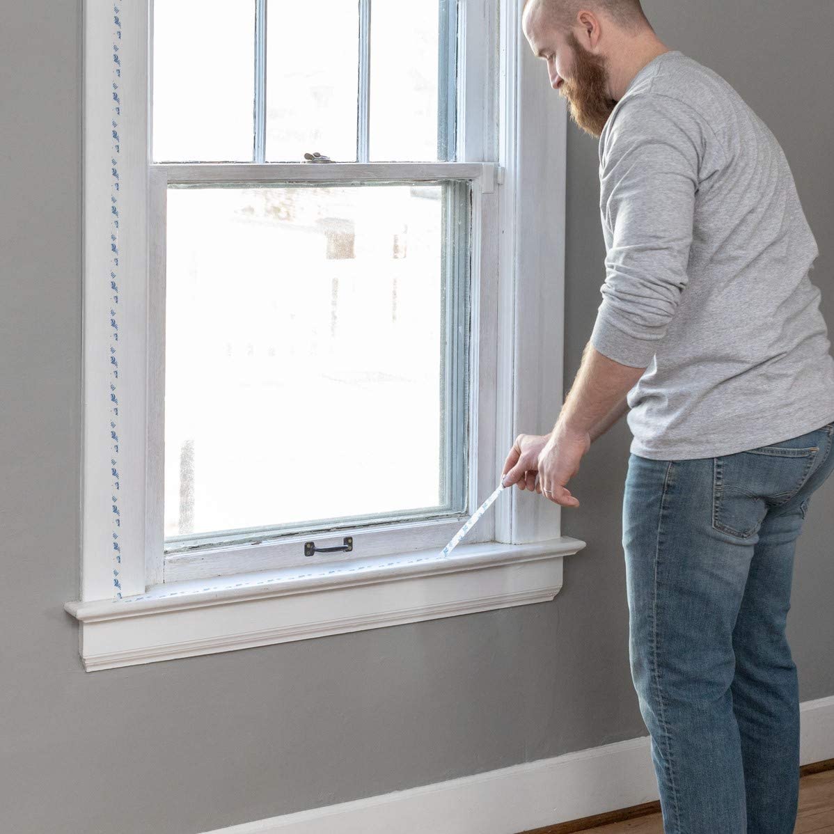 Amazon winterize your rental applying window insulation film.jpg