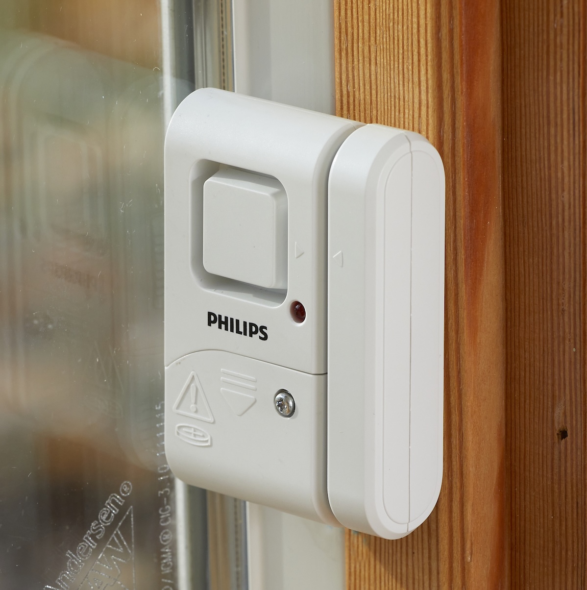 A glass break sensor is positioned on the window trim next to the window.