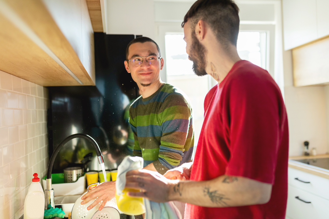 iStock-1265617778 cleaning resoultions same sex couple washing dishes.jpg