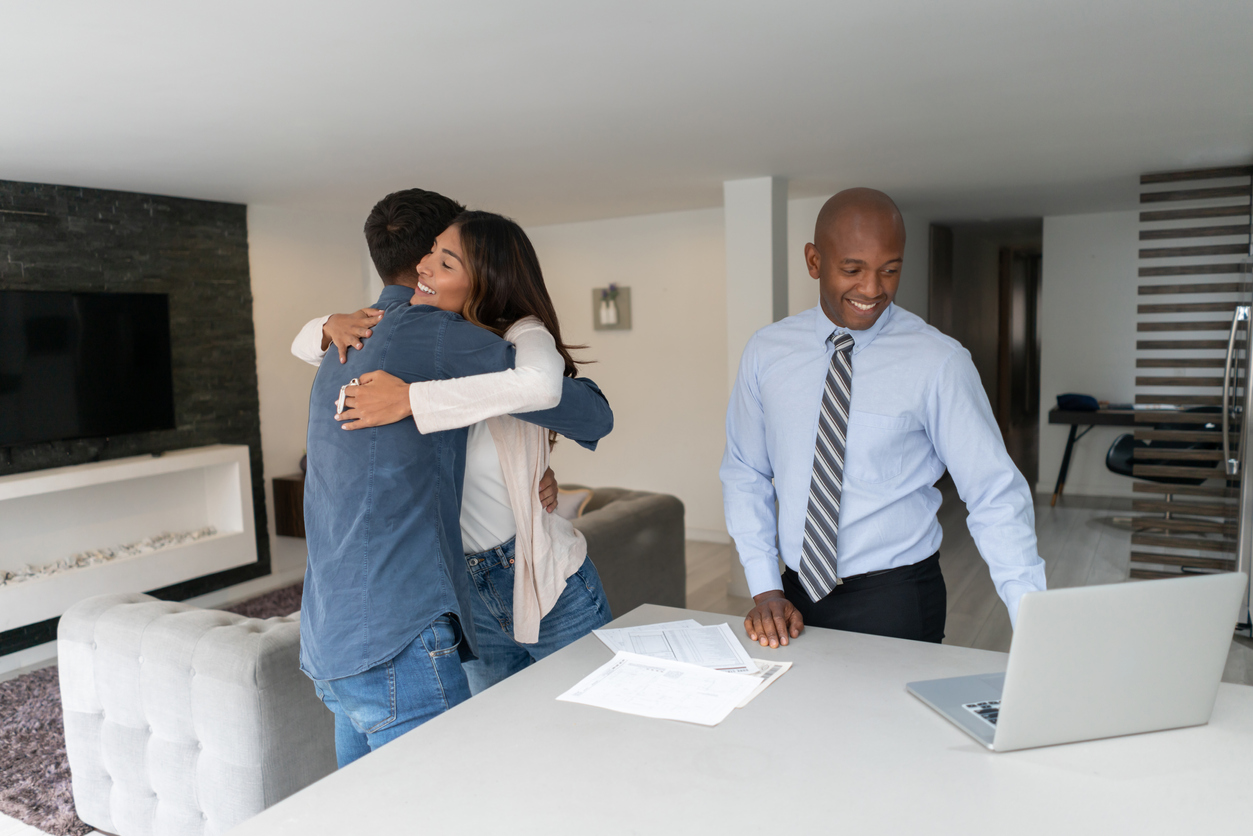 iStock-1325947424 how real estate changed real estate agent with happy couple.jpg