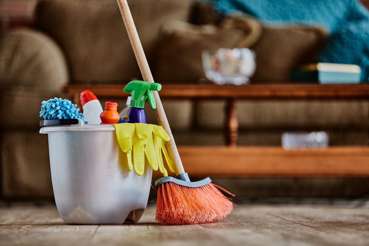 iStock-1328423673 Forbidden New Years Chore Broom and Cleaning supplies on living room floor.jpg