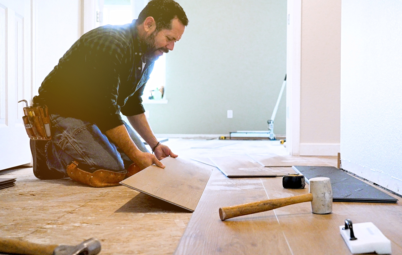iStock-1360852218 short term rental renovations installing vinyl plank flooring.jpg