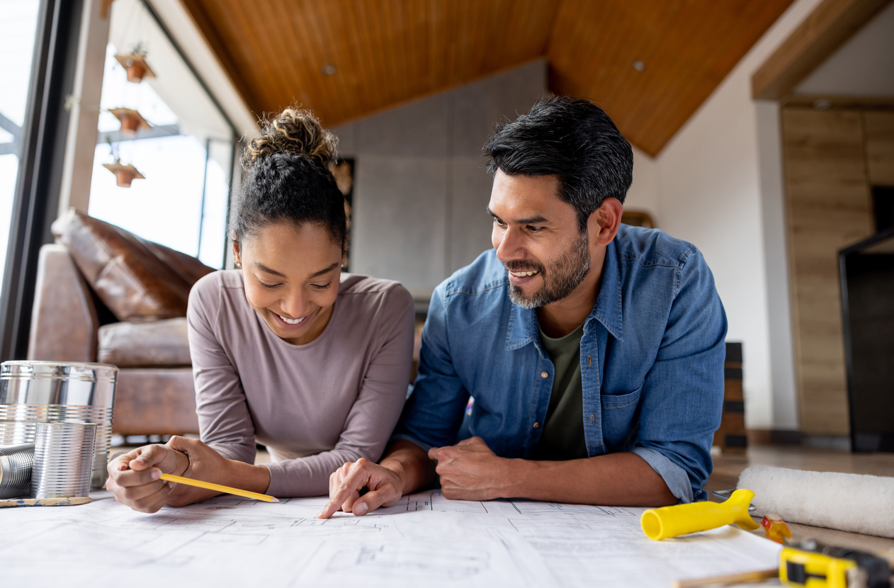iStock-1367252666 must dos January Couple remodeling their house and looking at blueprints stock photo.jpg