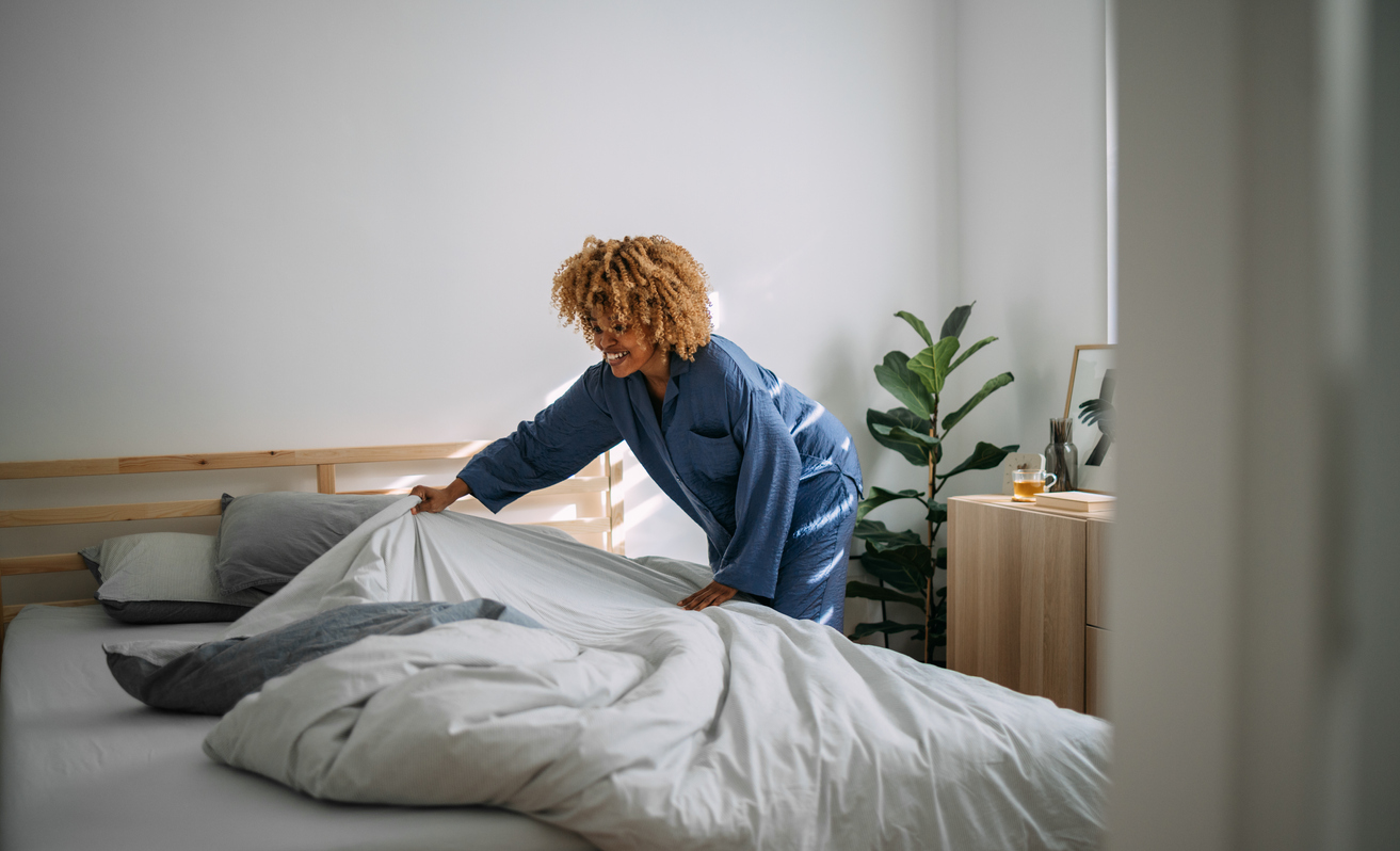 iStock-1388450631 cleaning resolutions woman making bed.jpg