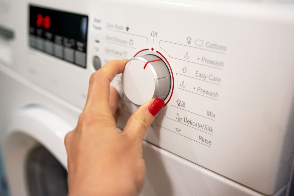 ways to save money at home - turning washing machine knob