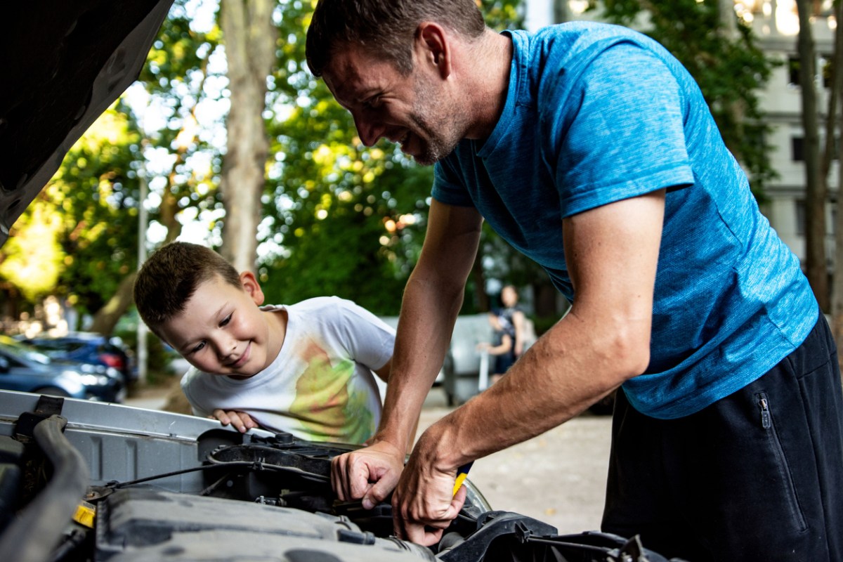iStock-1410806701 stocking stuffers for car lovers dad and son working on car.jpg