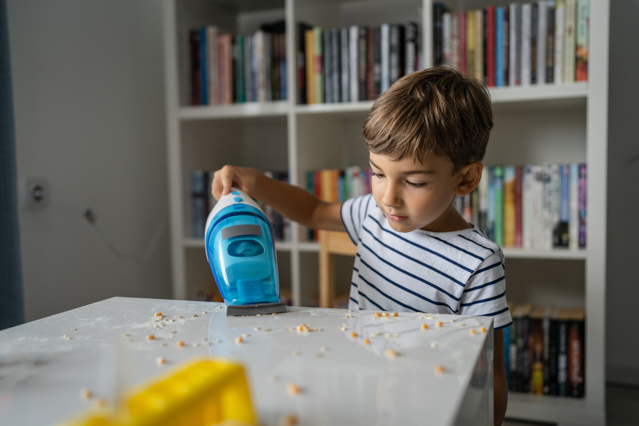 iStock-1424410473 cleaning resolutions young kid vacuuming playroom.jpg