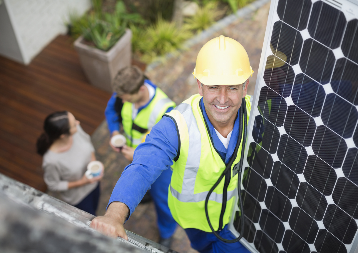iStock-169270315 rebates and tax credits technician installing solar panels.jpg