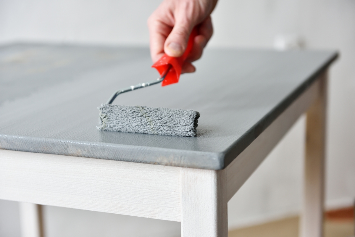 can you paint particle board - paint roller on table